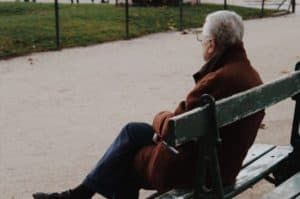 elderly-man-sitting-on-bench-in-park-during-autumn-day-1838466-683x1024