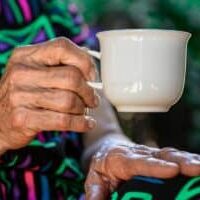 Older lady holding cup